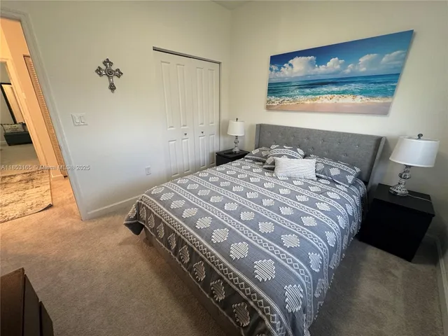 a bedroom with a bed and painting on the wall