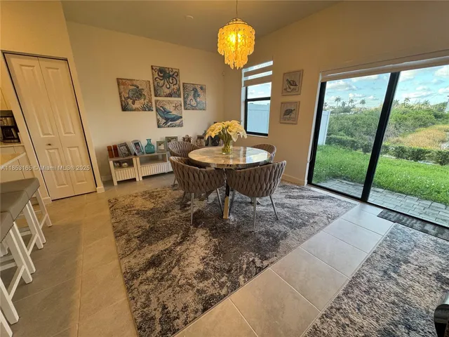 a living room with furniture a chandelier and a large window