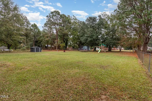 a view of a field with an trees