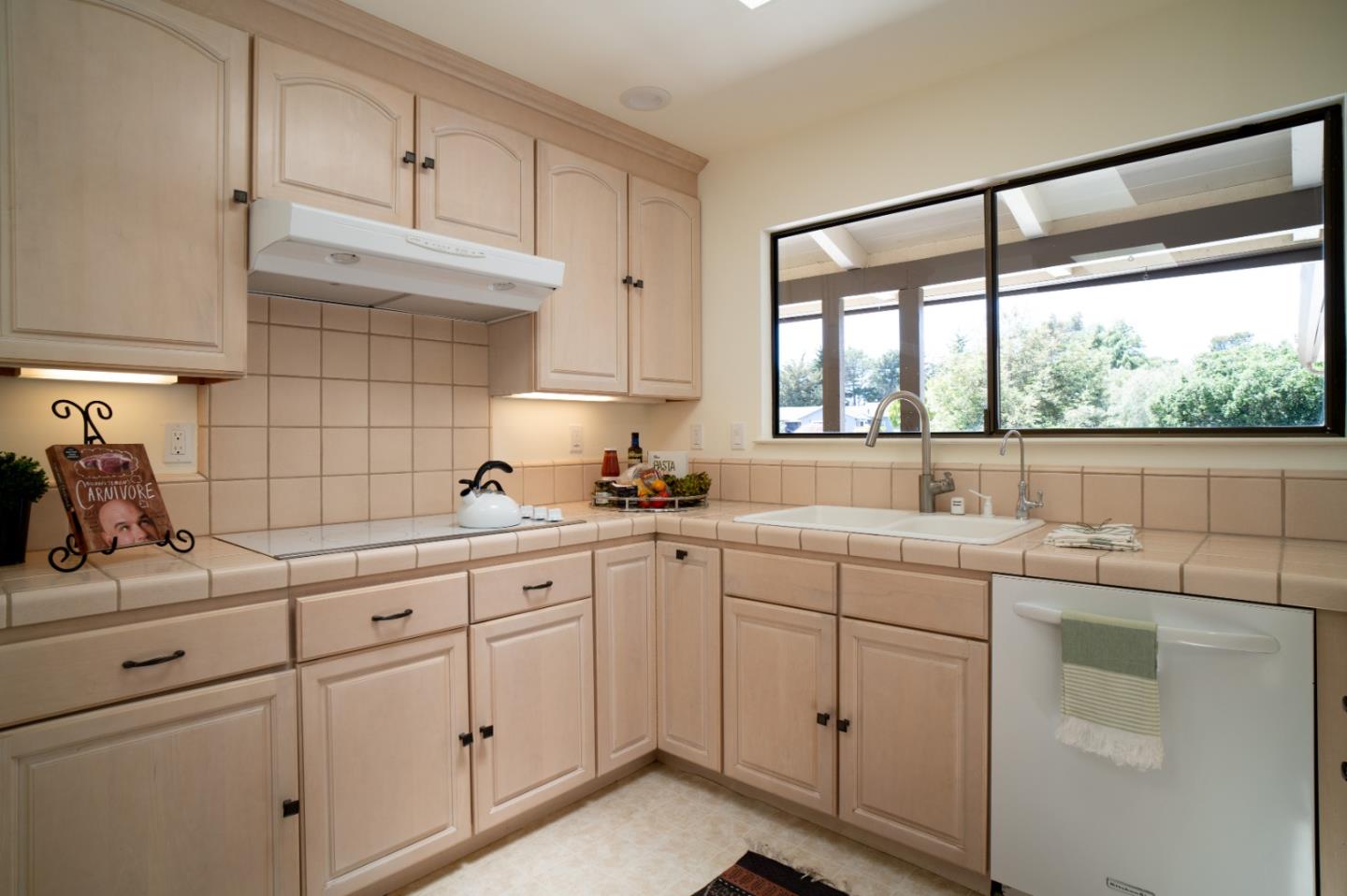 25815 Rio Vista Drive Carmel, CA 93923 - Photo 11 of 49 a kitchen with white cabinets and white appliances