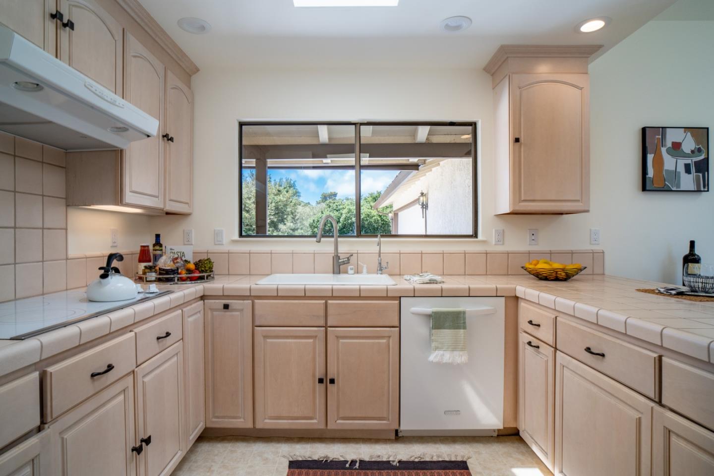 25815 Rio Vista Drive Carmel, CA 93923 - Photo 12 of 49 a kitchen with white cabinets and white appliances