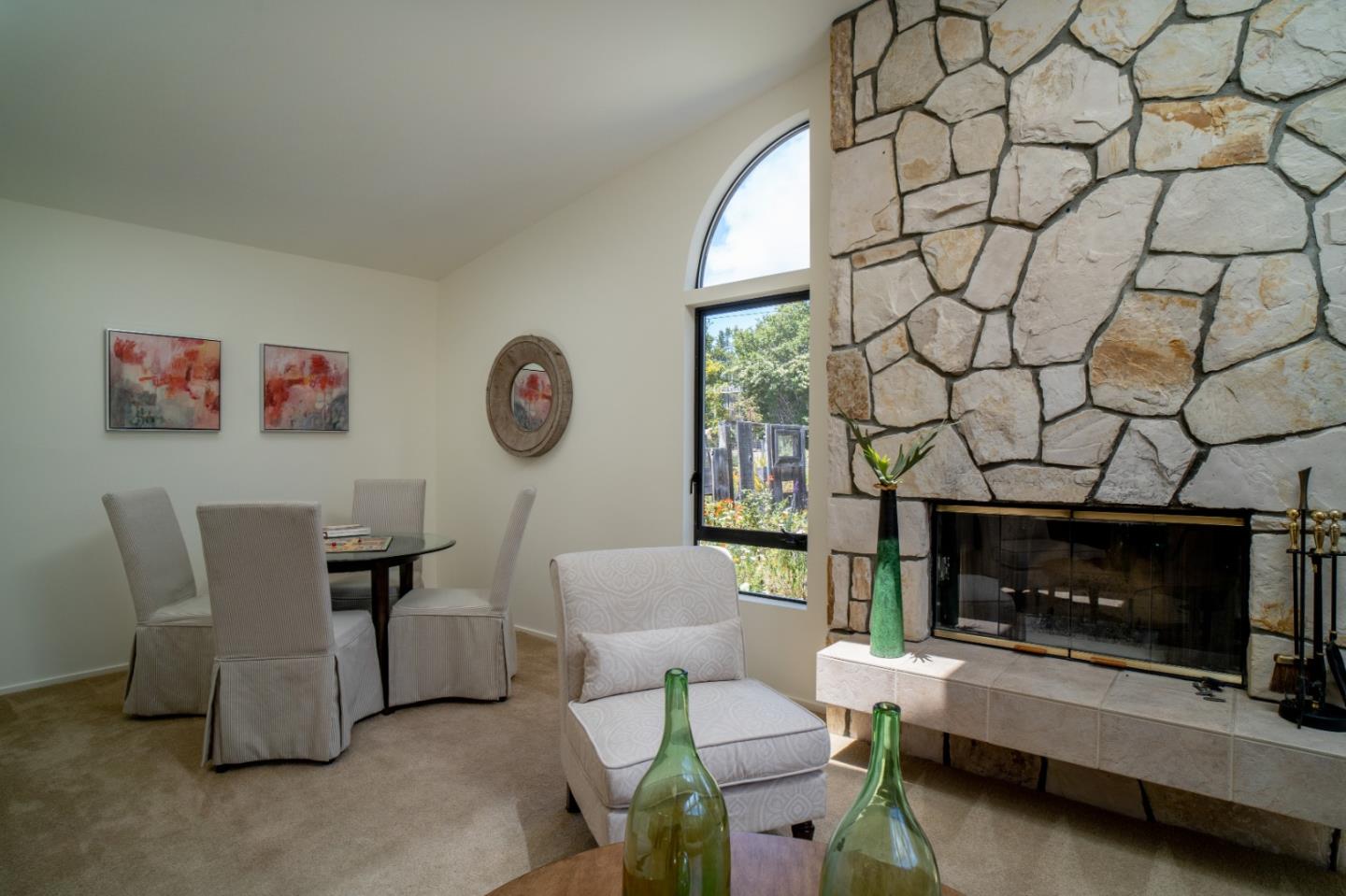 25815 Rio Vista Drive Carmel, CA 93923 - Photo 18 of 49 a living room with furniture a fireplace and a table