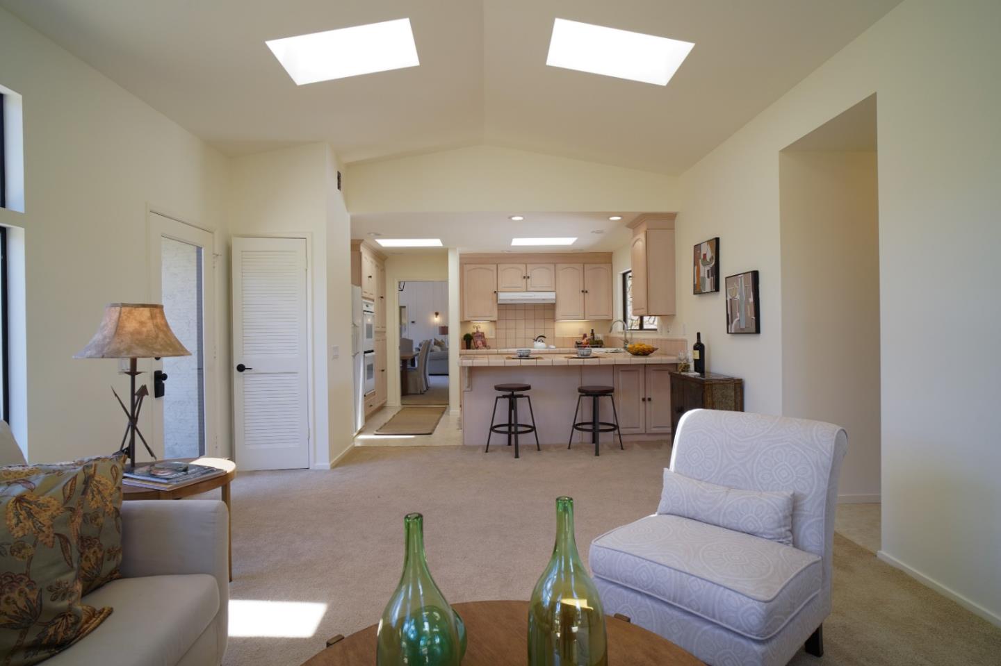 25815 Rio Vista Drive Carmel, CA 93923 - Photo 20 of 49 a living room with furniture and a dining table with kitchen view