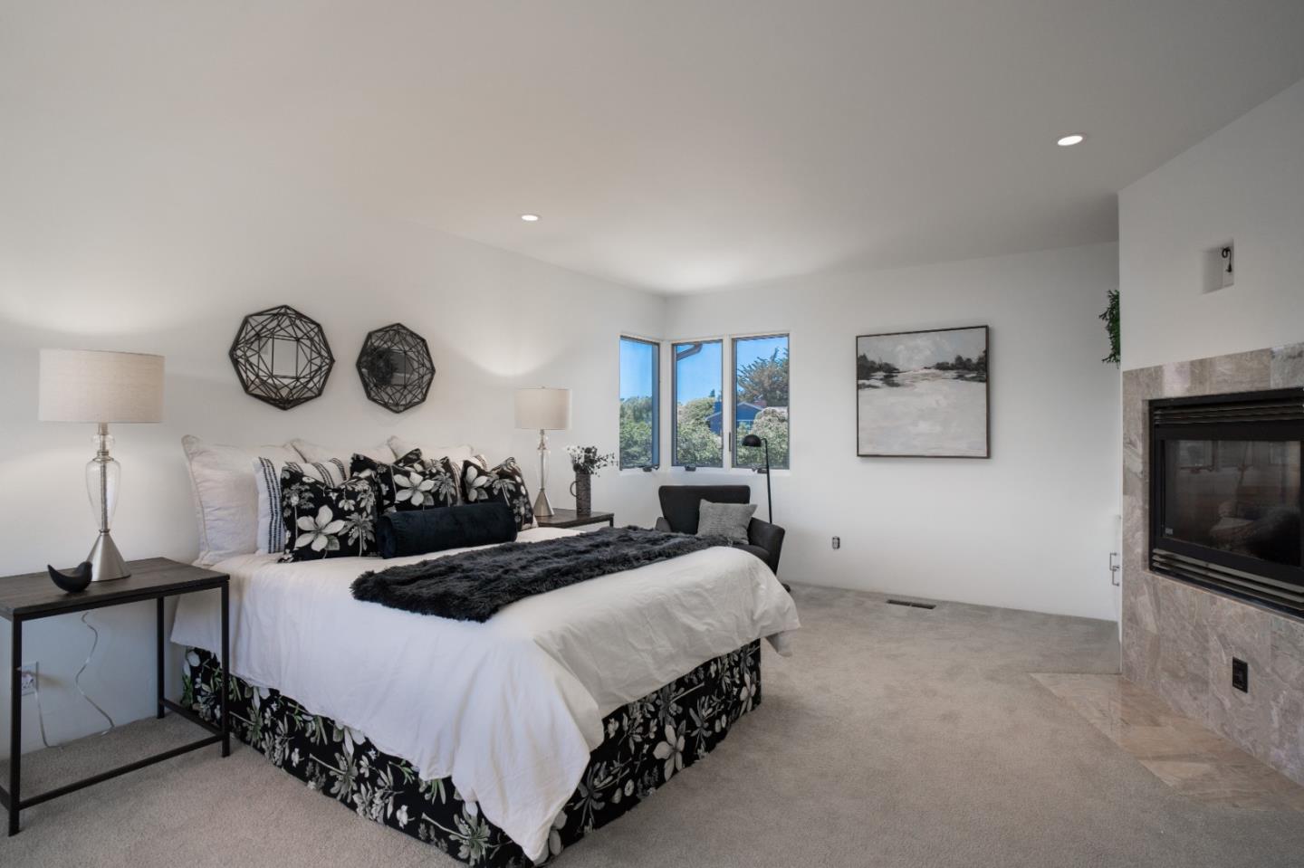 25815 Rio Vista Drive Carmel, CA 93923 - Photo 22 of 49 a bedroom with bed and a flat tv screen on dresser