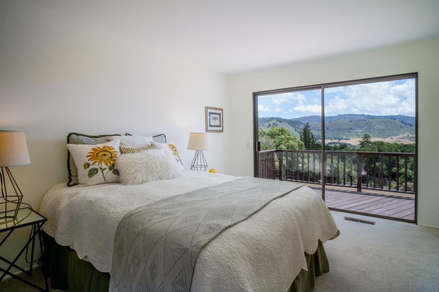 25815 Rio Vista Drive Carmel, CA 93923 - Photo 26 of 49 a bedroom with a balcony a bed and a large window