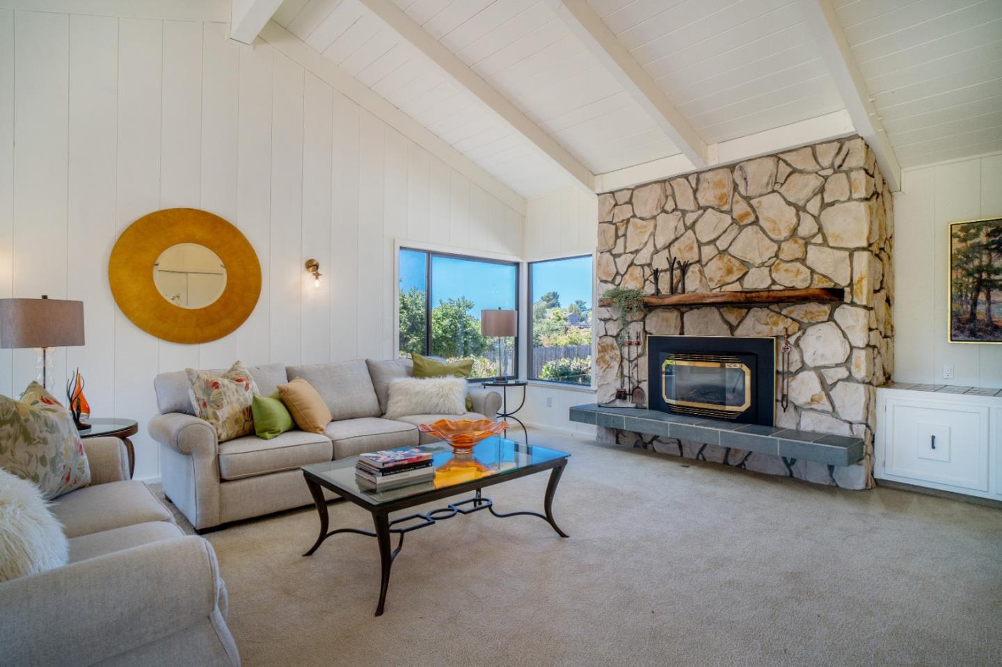 25815 Rio Vista Drive Carmel, CA 93923 - Photo 6 of 49 a living room with furniture a fireplace and a wall painting