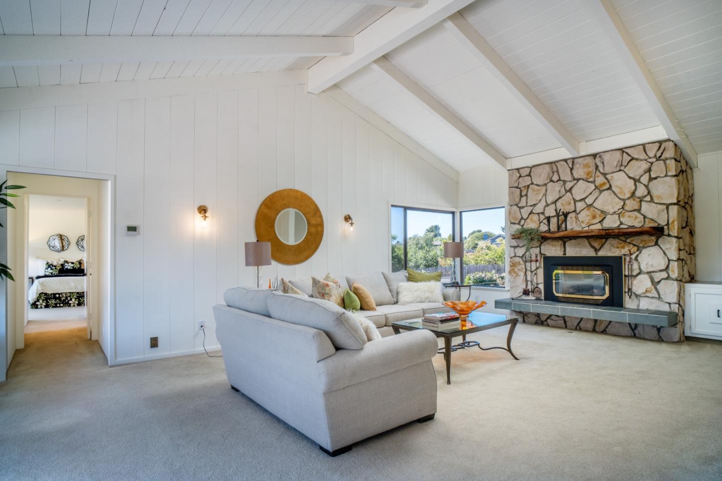 25815 Rio Vista Drive Carmel, CA 93923 - Photo 8 of 49 a living room with furniture a fireplace and a floor to ceiling window