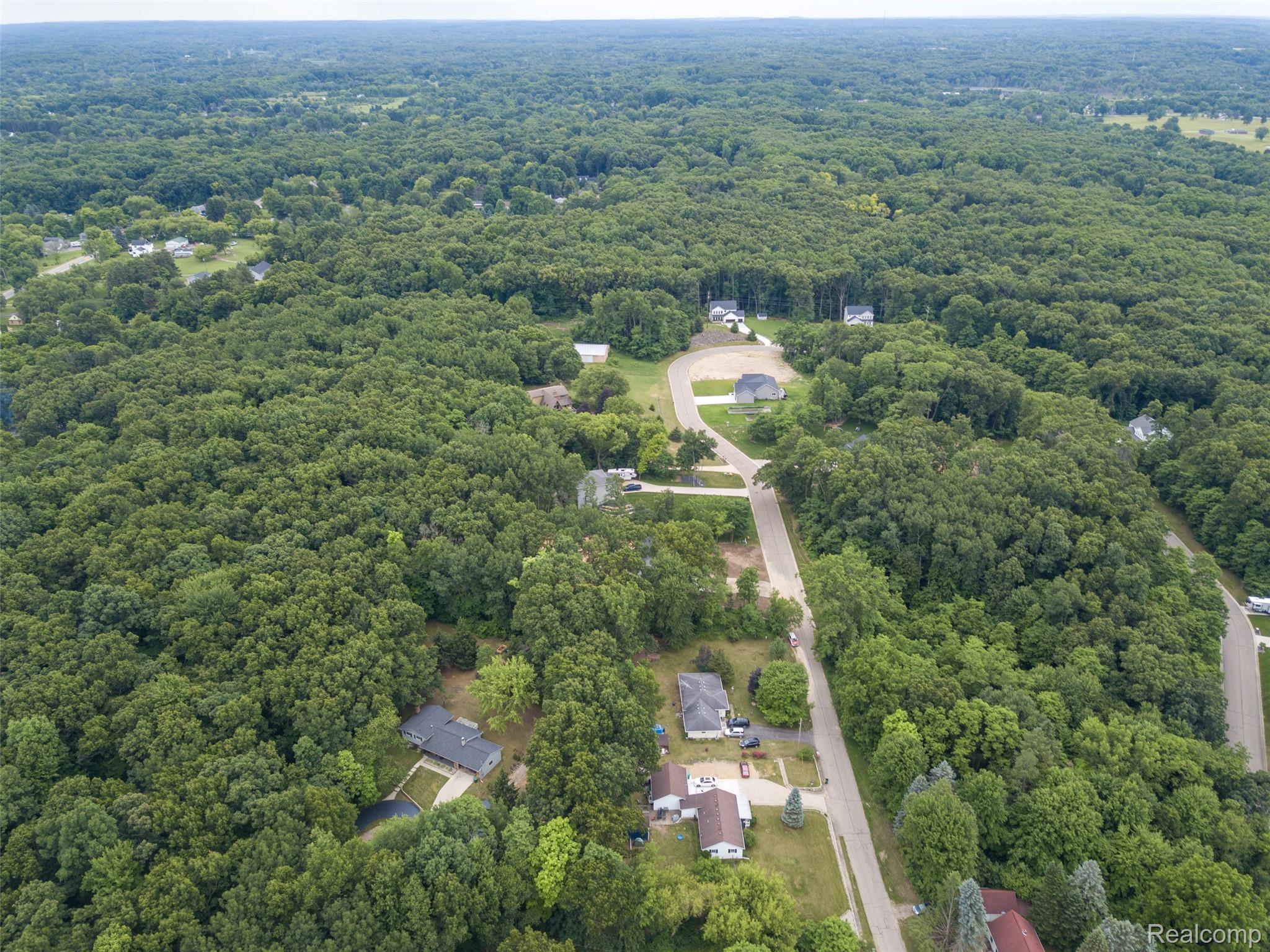 16085 Catalpa Ridge Holly, MI 48442 - Photo 34 of 40 Expansive wooded landscape featuring scattered residential properties and paved roads