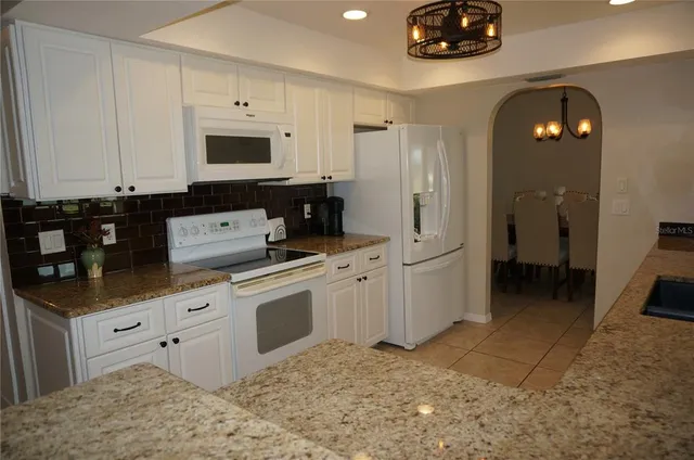 a kitchen with stainless steel appliances granite countertop a sink and cabinets
