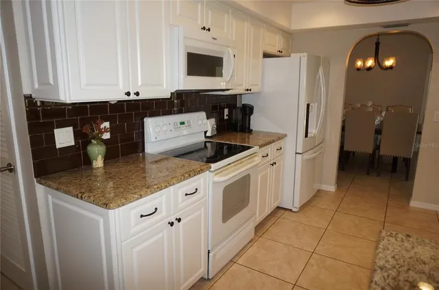 a kitchen with stainless steel appliances granite countertop a sink and a cabinets
