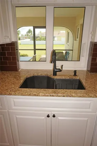 a view of a dining room with furniture and a potted plant