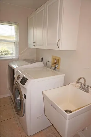 a spacious bedroom with a bed and a table in it