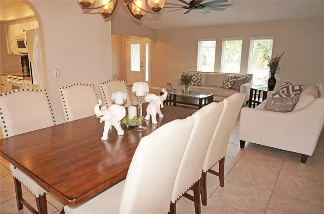 a view of a dining room with furniture and a chandelier