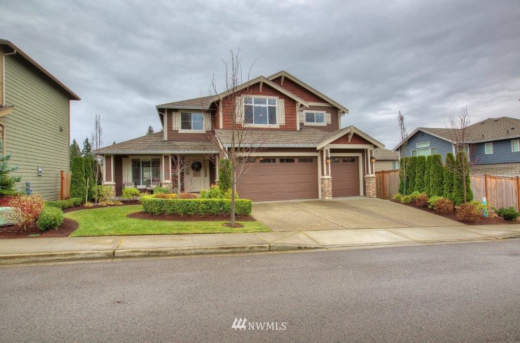 6209 Northeast 1st Street Renton, WA 98059 - Photo 1 of 1 a front view of a house with a yard and garage