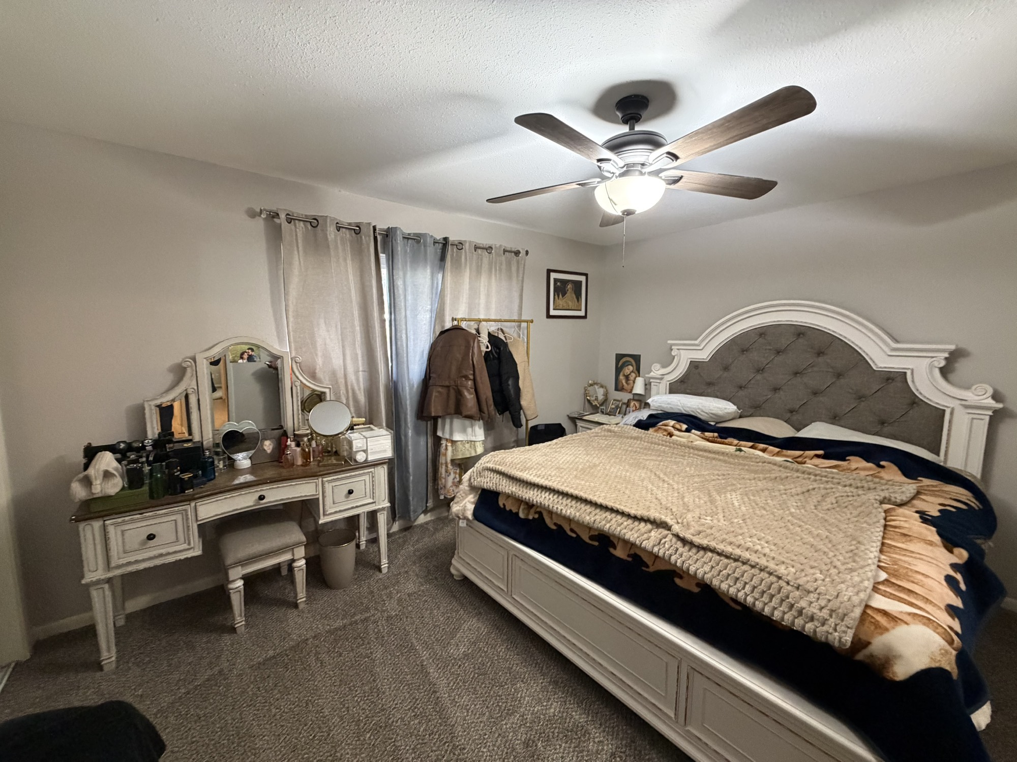 9022 Lazy River Lane Houston, TX 77088 - Photo 6 of 23 a bedroom with a bed and a chandelier