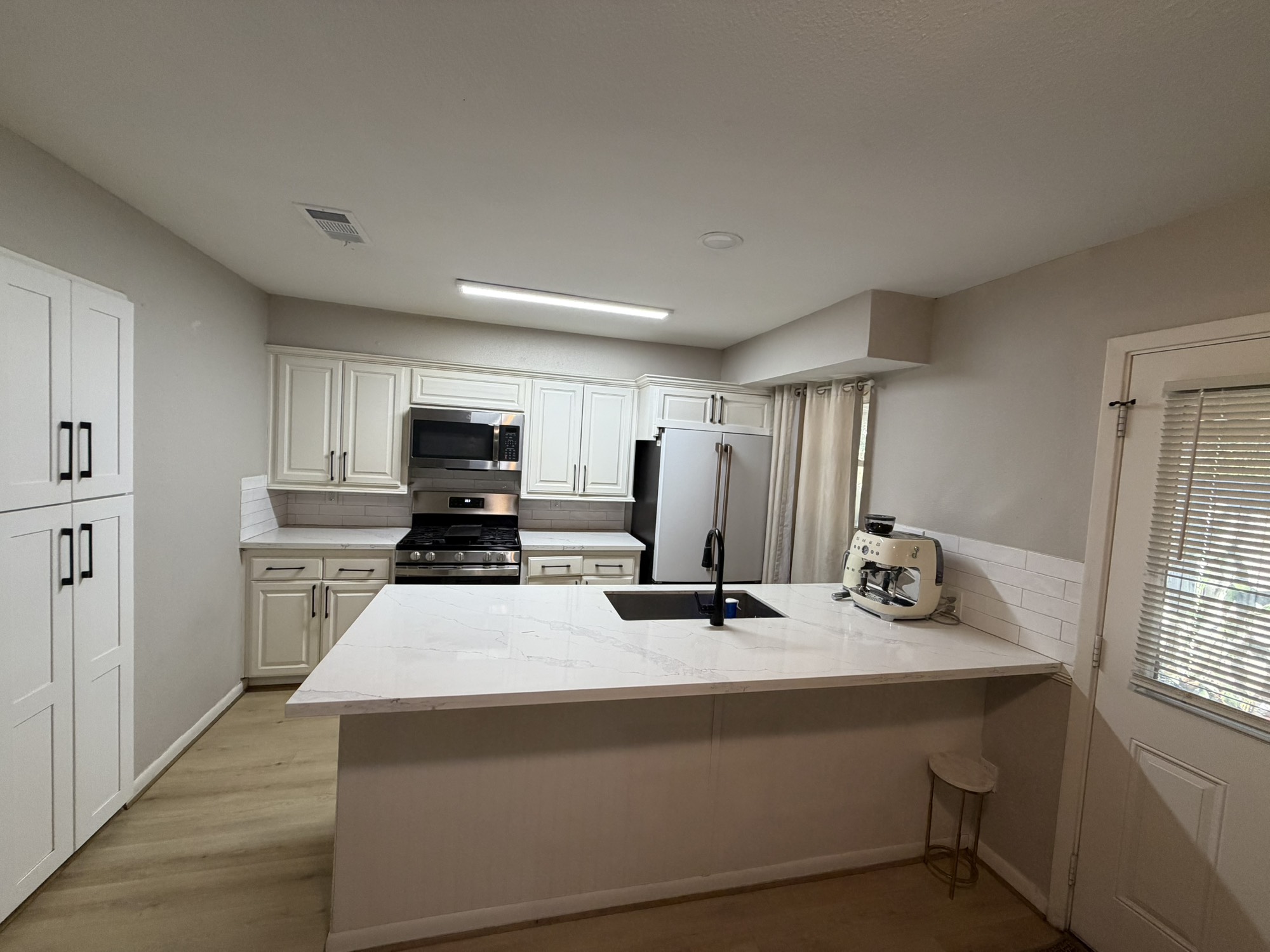 9022 Lazy River Lane Houston, TX 77088 - Photo 9 of 23 a kitchen with kitchen island sink stove and refrigerator