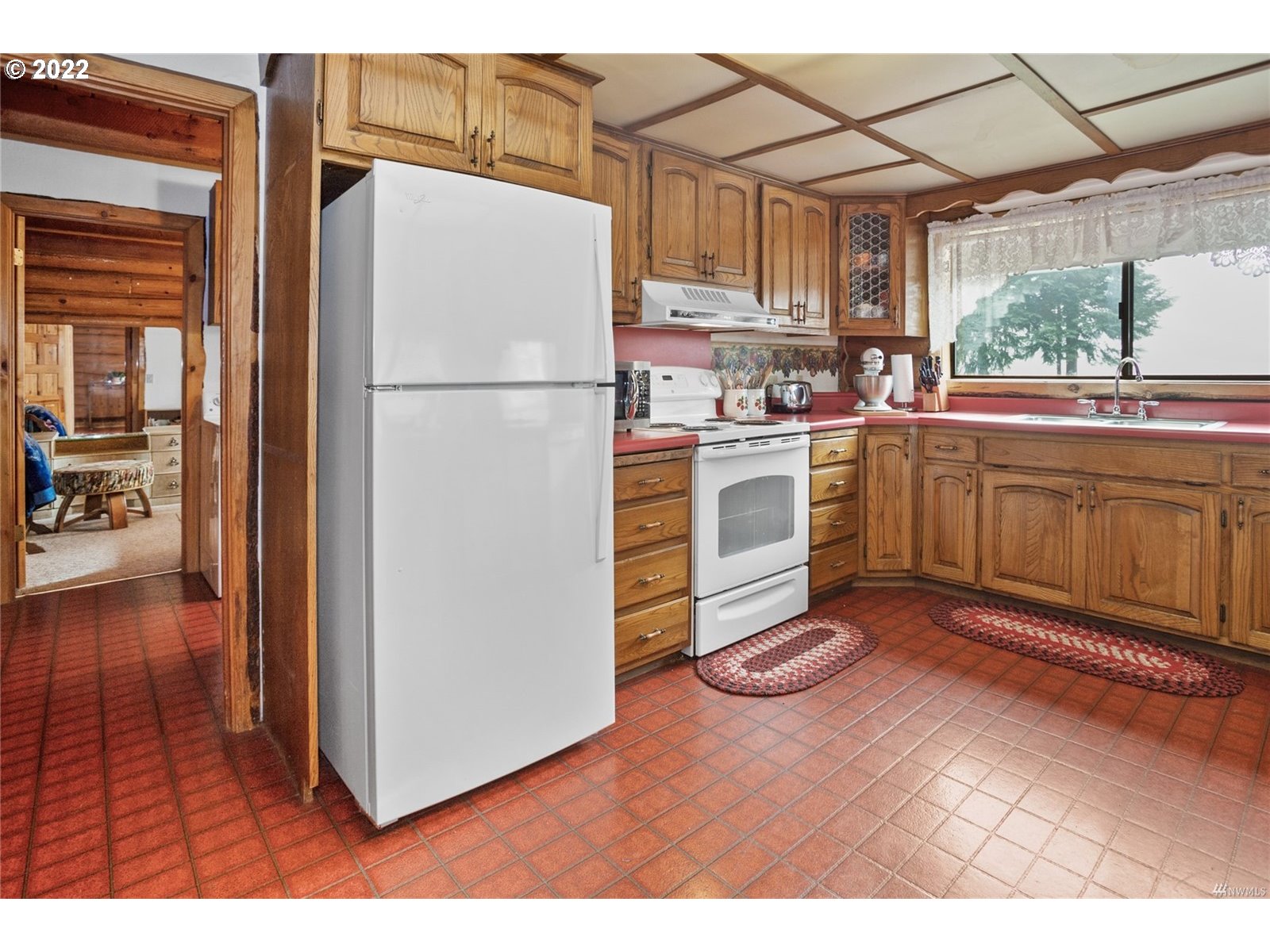 248 Coma Road Winlock, WA 98596 - Photo 12 of 30 a kitchen with cabinets and wooden floor
