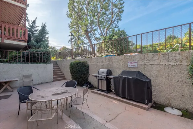 a view of a patio with table and chairs and potted plants