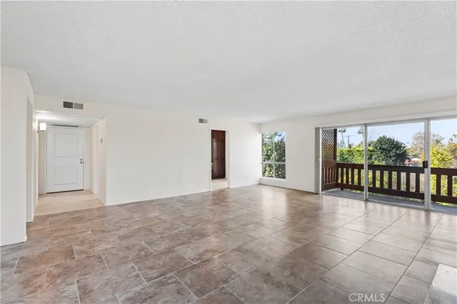 a view of an empty room with glass door