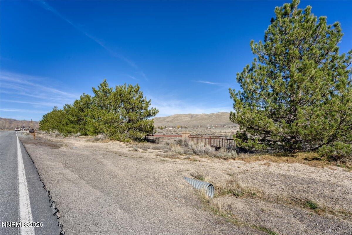 15210 North Red Rock Road Reno, NV 89508 - Photo 30 of 30 a view of a dry yard with trees in the background