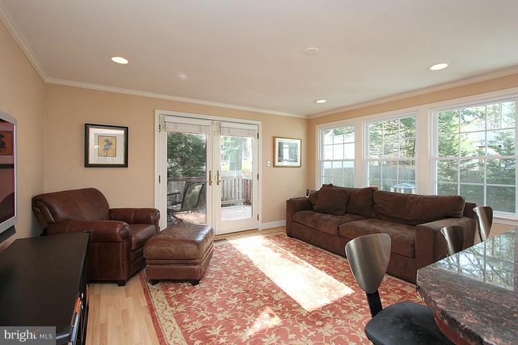 8209 Maple Ridge Road Bethesda, MD 20814 - Photo 14 of 26 Family Room with wall of windows & door to Deck