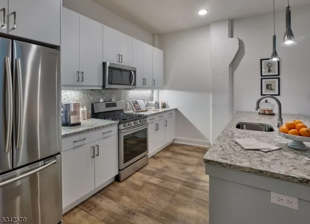 a kitchen with a sink stove and refrigerator