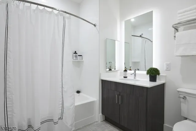 a bathroom with a sink a toilet and tub