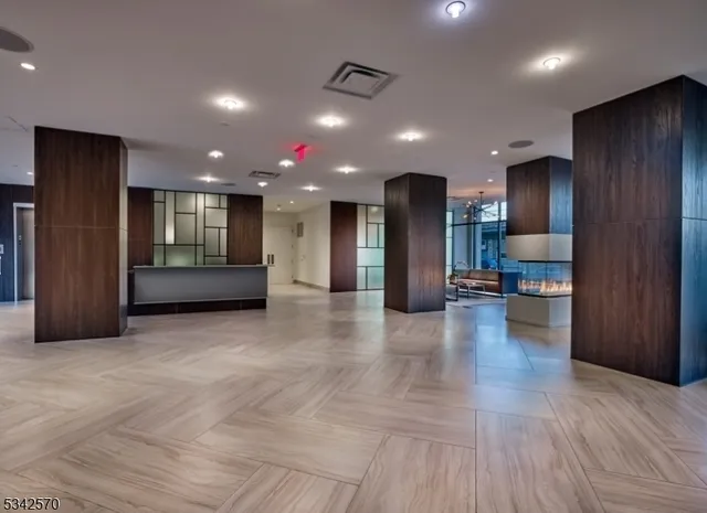 a kitchen with granite countertop kitchen island stainless steel appliances a sink stove and cabinets