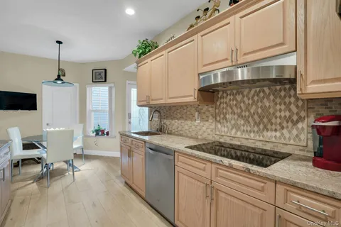 a kitchen with granite countertop a refrigerator and a stove top oven