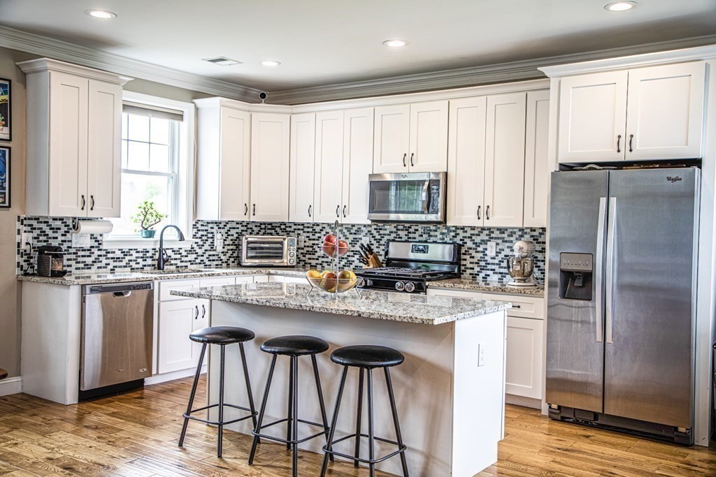 27 Fay Road, Unit 27 Framingham, MA 01702 - Photo 1 of 32 a kitchen with stainless steel appliances granite countertop white cabinets a sink stove and refrigerator