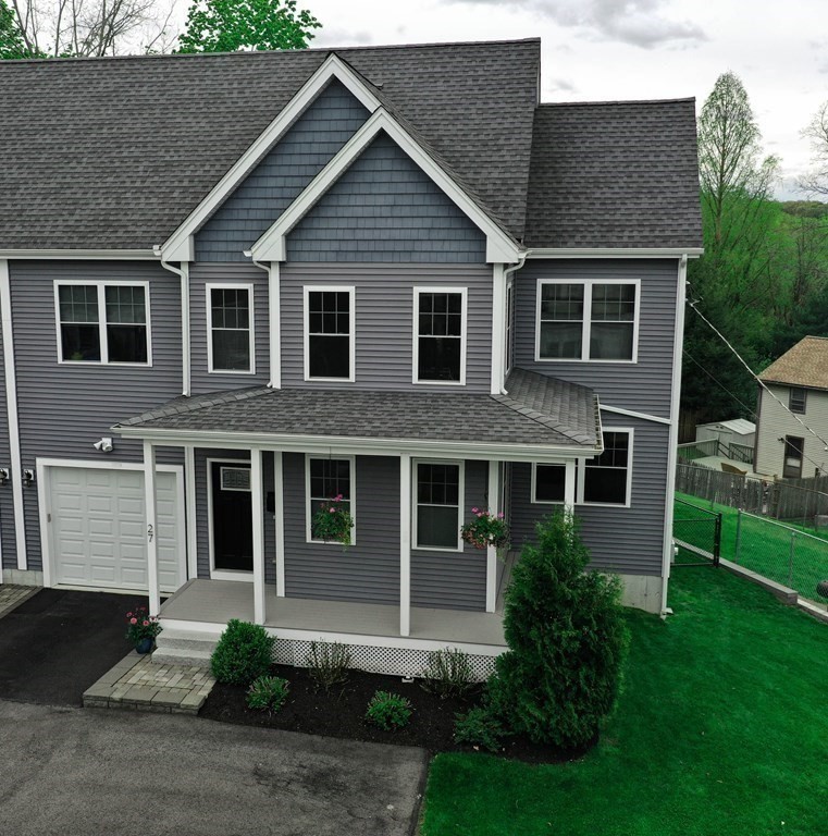 27 Fay Road, Unit 27 Framingham, MA 01702 - Photo 2 of 32 a front view of a house with a yard and garage
