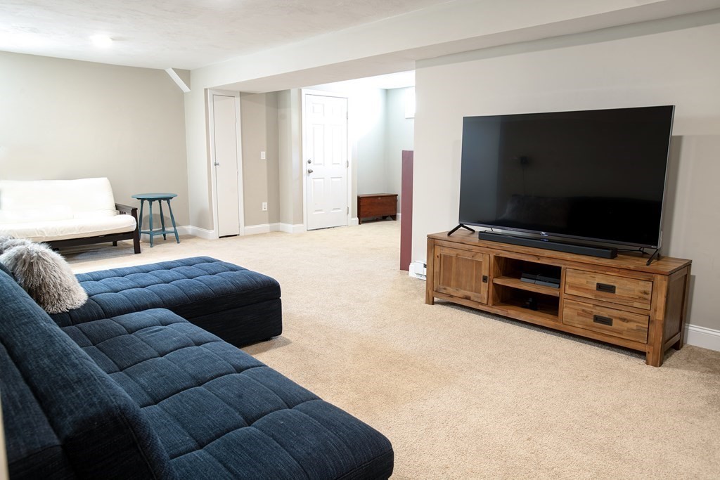 27 Fay Road, Unit 27 Framingham, MA 01702 - Photo 22 of 32 a living room with furniture and a flat screen tv
