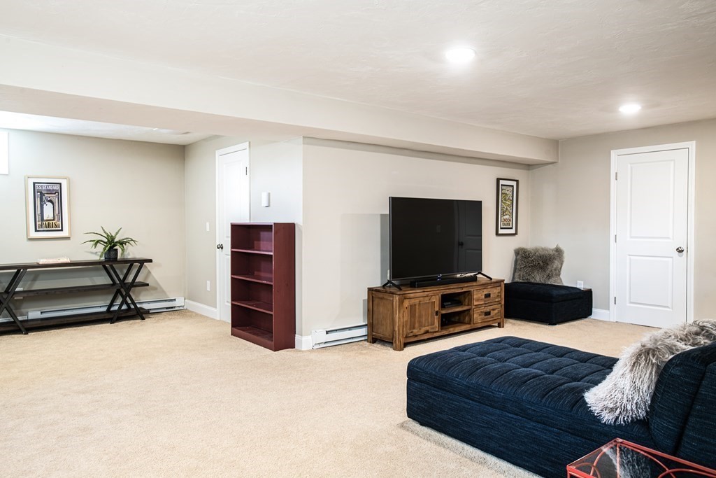 27 Fay Road, Unit 27 Framingham, MA 01702 - Photo 23 of 32 a bedroom with furniture and a flat screen tv
