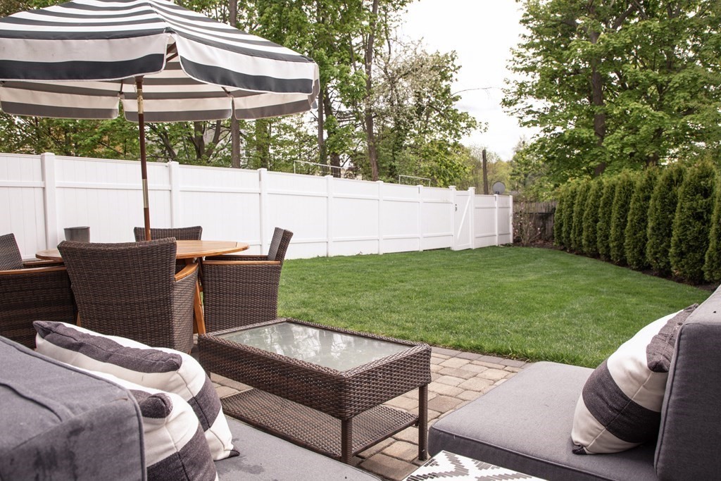 27 Fay Road, Unit 27 Framingham, MA 01702 - Photo 26 of 32 a backyard of a house with table and chairs