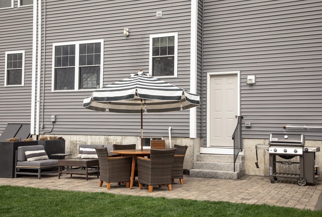 27 Fay Road, Unit 27 Framingham, MA 01702 - Photo 27 of 32 a backyard of a house with outdoor seating