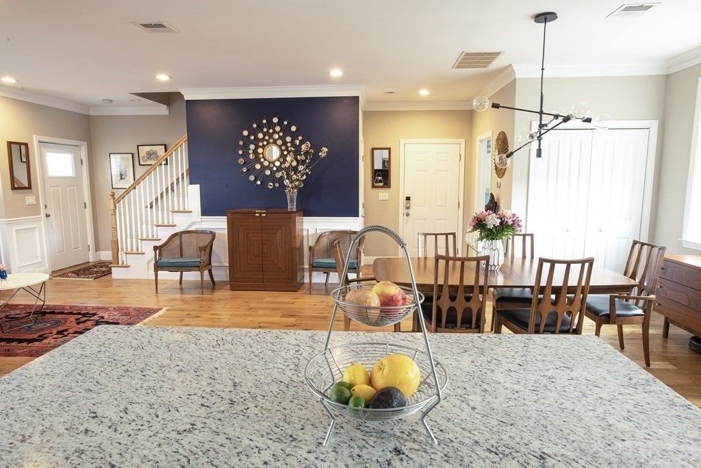 27 Fay Road, Unit 27 Framingham, MA 01702 - Photo 5 of 32 a view of a dining room and livingroom with furniture wooden floor a chandelier