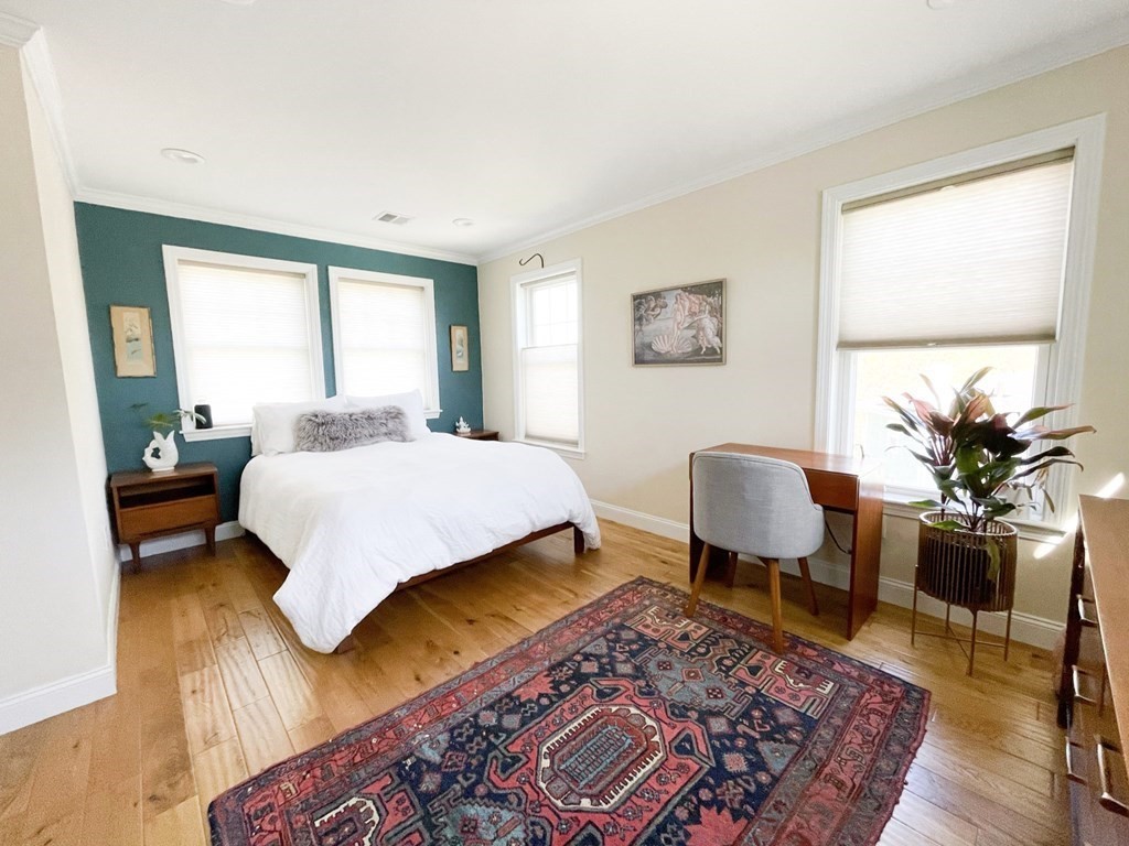 27 Fay Road, Unit 27 Framingham, MA 01702 - Photo 9 of 32 a bedroom with a bed wooden floor and a lamp on table