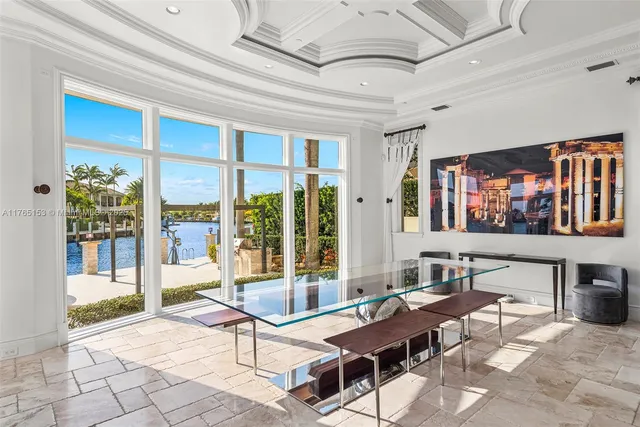 a view of a swimming pool with chairs in front of house