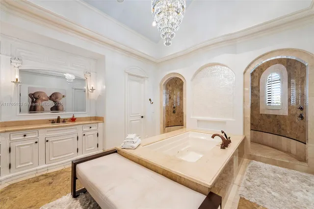 a bedroom with a bed ceiling fan and a large window