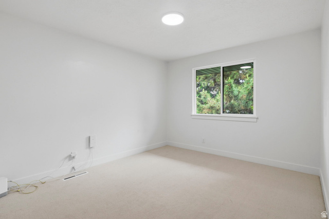 4150 Dover Lane Provo, UT 84604 - Photo 21 of 44 Neutral-toned carpeting extends throughout this room, featuring a white window frame with a multi-pane window