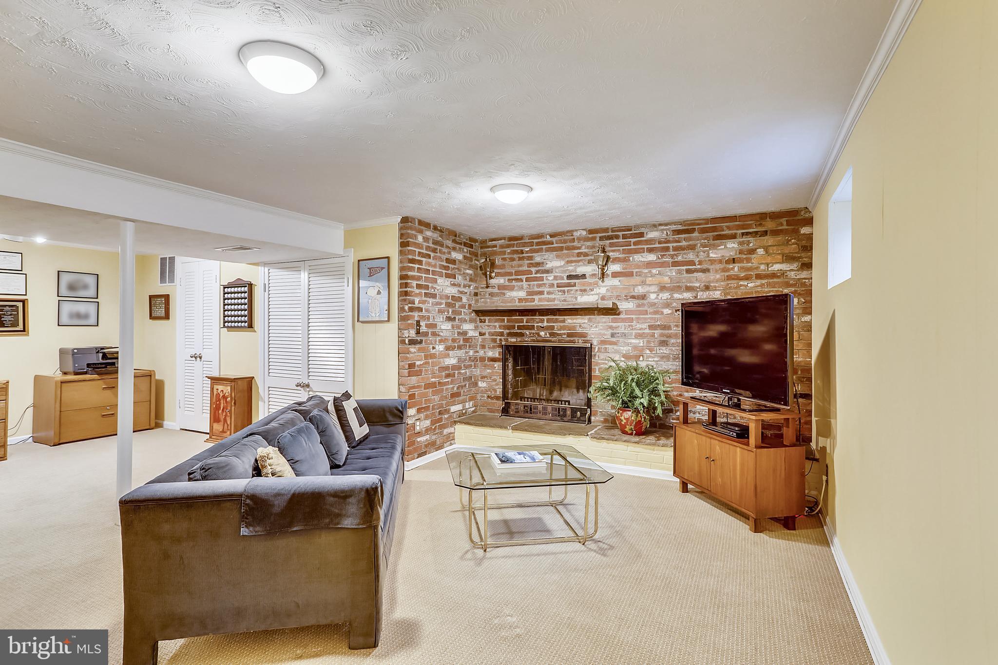 5016 Sangamore Road Bethesda, MD 20816 - Photo 22 of 31 Lower level recreation room with fireplace