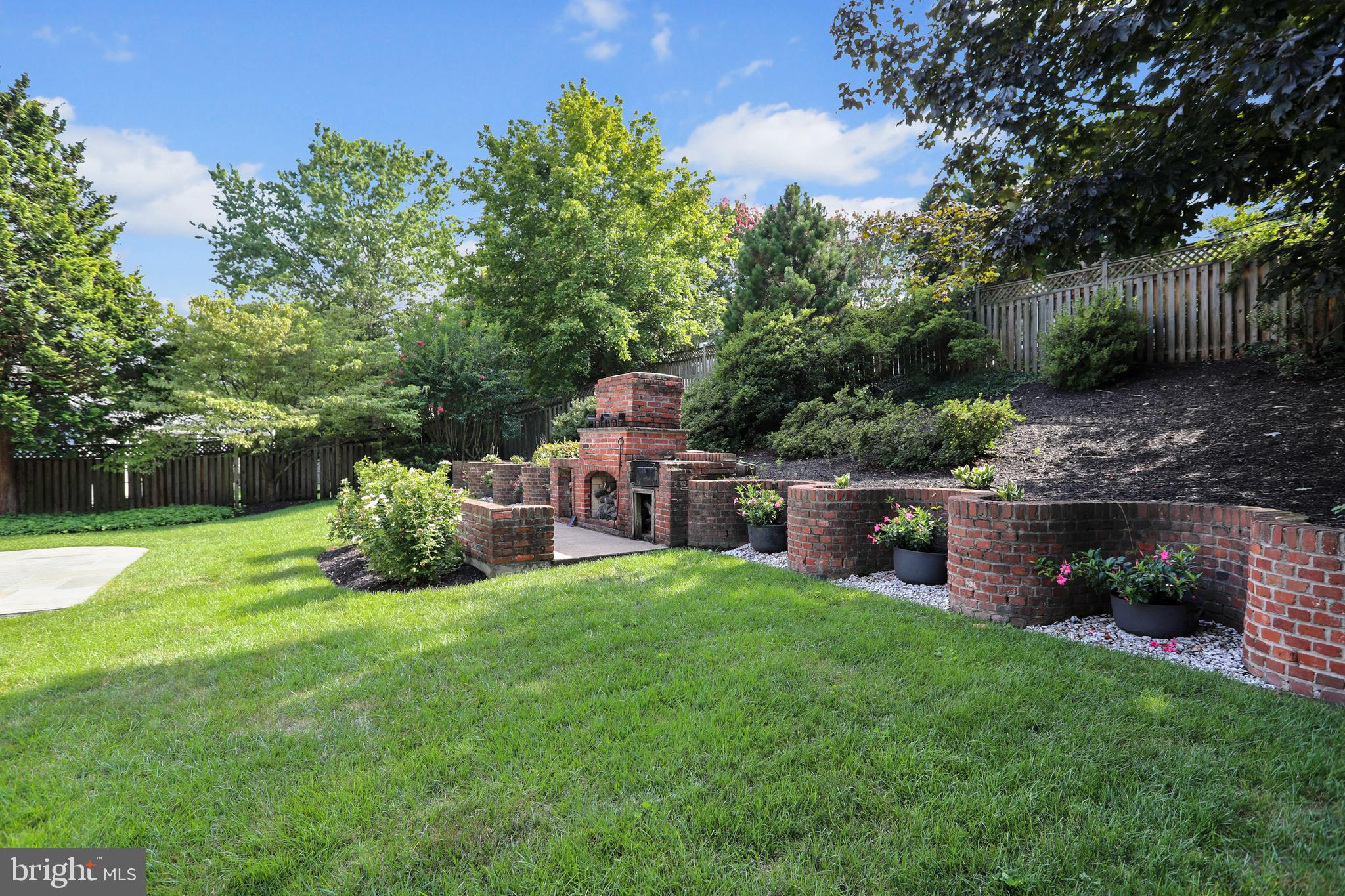 5016 Sangamore Road Bethesda, MD 20816 - Photo 27 of 31 Backyard with Serpentine brick wall