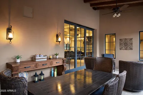 a living room with furniture and a floor to ceiling window