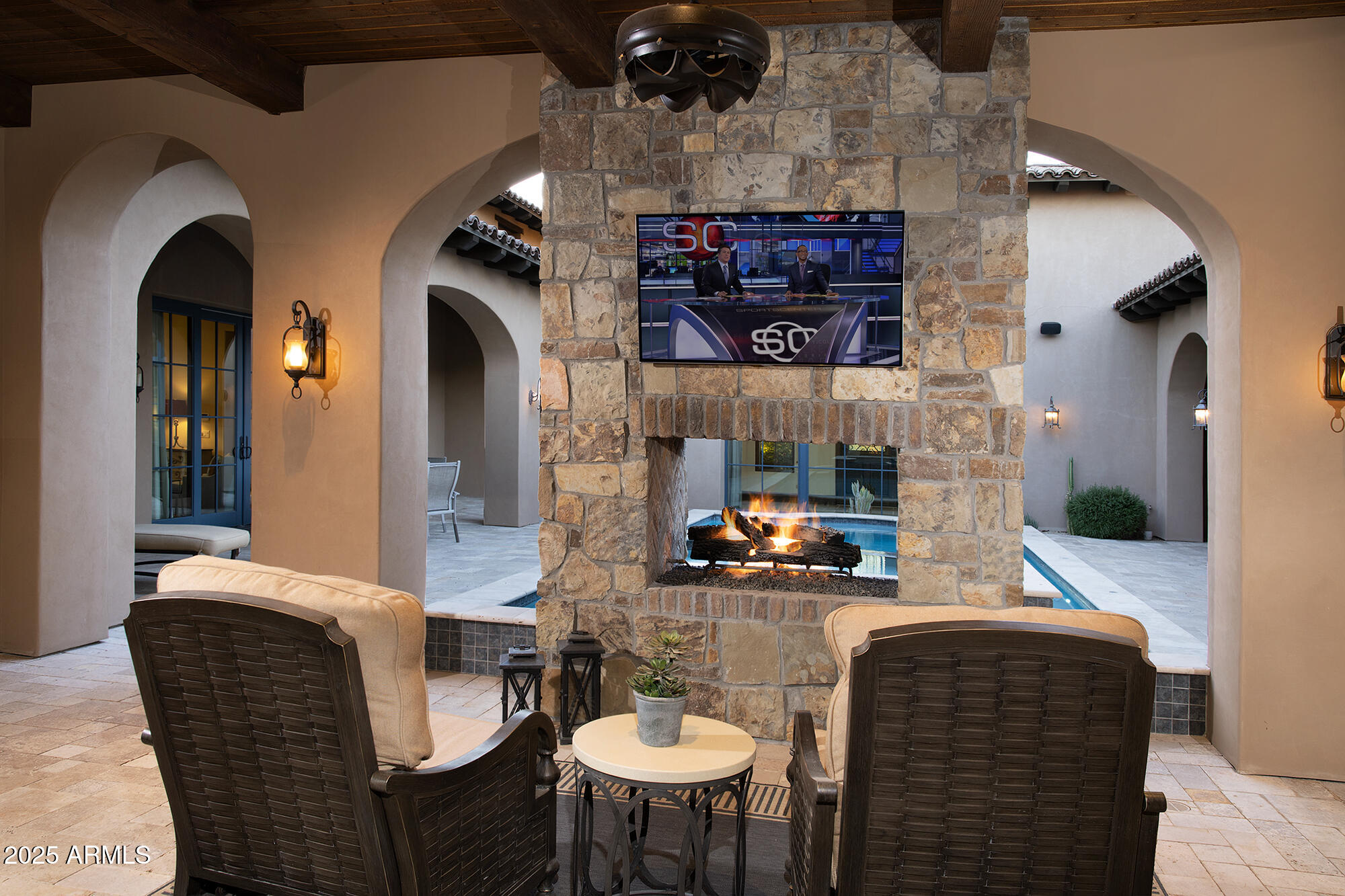 19481 North 98th Place Scottsdale, AZ 85255 - Photo 15 of 34 a dining room with furniture and a fireplace