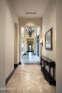 a view of a big room with a fireplace and a chandelier