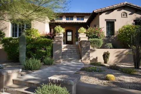 a front view of a house with garden