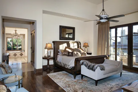 a bedroom with a bed a couch and a window