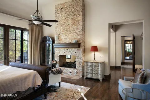 a bedroom with a bed mirror and window