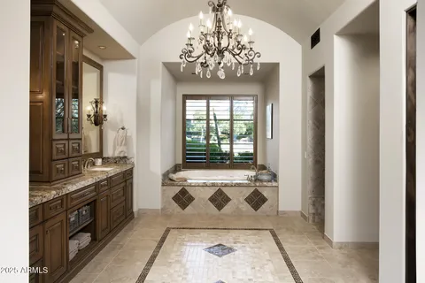 a spacious bathroom with a granite countertop sink a mirror and shower