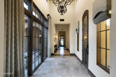 a view of hallway with large windows